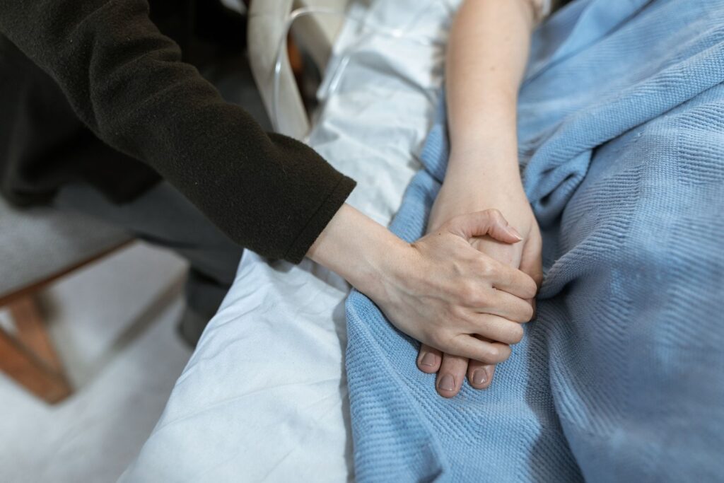 Therapist holding the hand of a patient during cancer treatment support